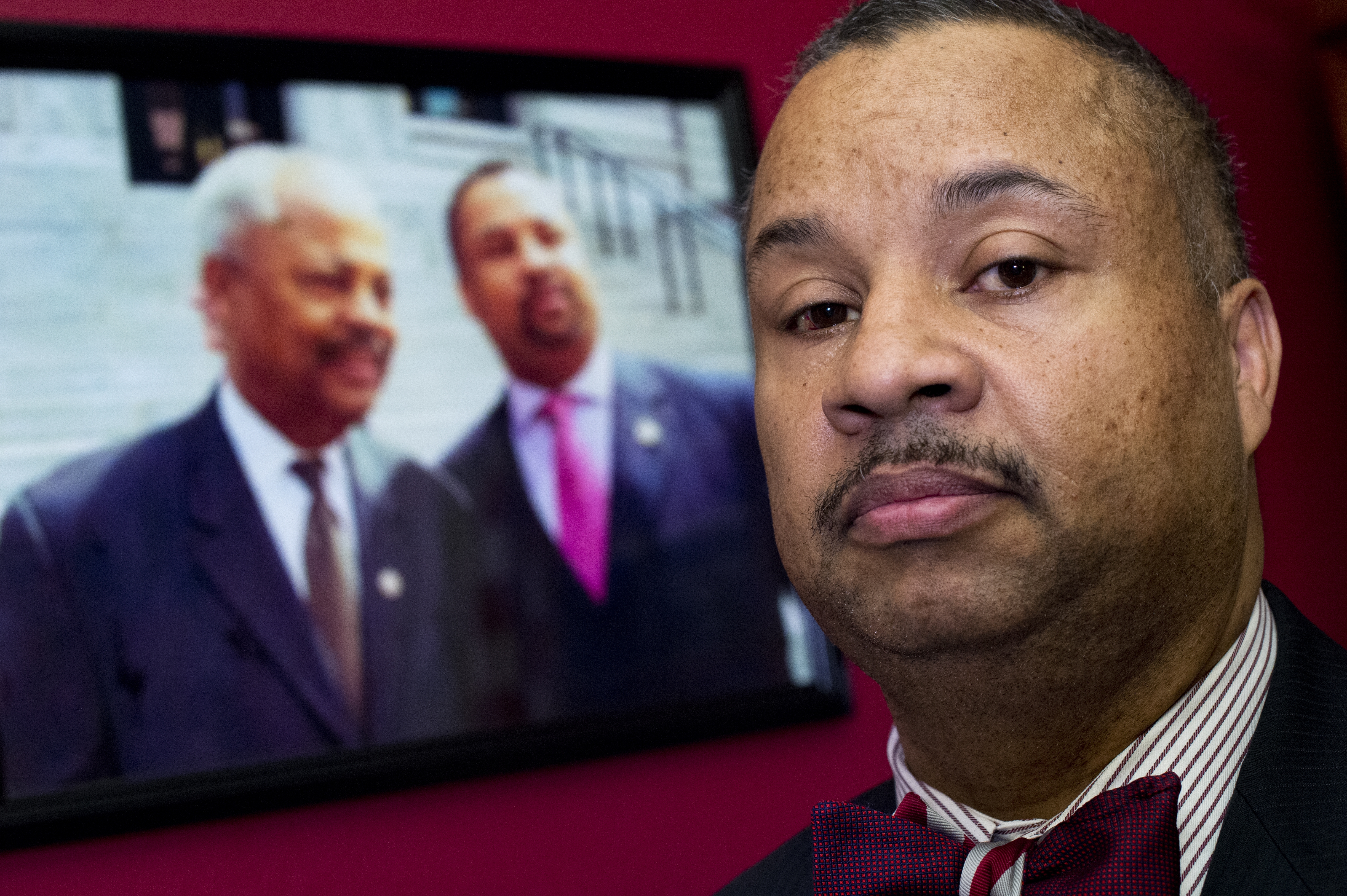 UNITED STATES - FEBRUARY 11: Rep. Donald Payne, Jr., D-N.J., is photographed in his Cannon Building office near a picture of himself and his late father former Rep. Donald Payne, D-N.J., February 11, 2016.(Photo By Tom Williams/CQ Roll Call)