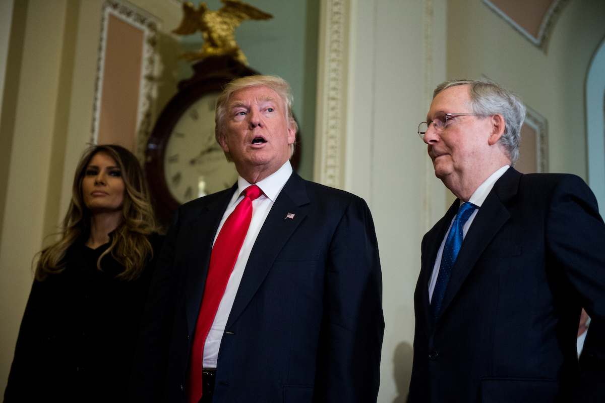 President-elect Donald Trump, escorted by Senate Majority Leader Mitch McConnell, R-Ky., takes a few questions from the press as he leaves with his wife Melania Trump after meeting with McConnell in the U.S. Capitol on Thursday. (Photo By Bill Clark/CQ Roll Call)