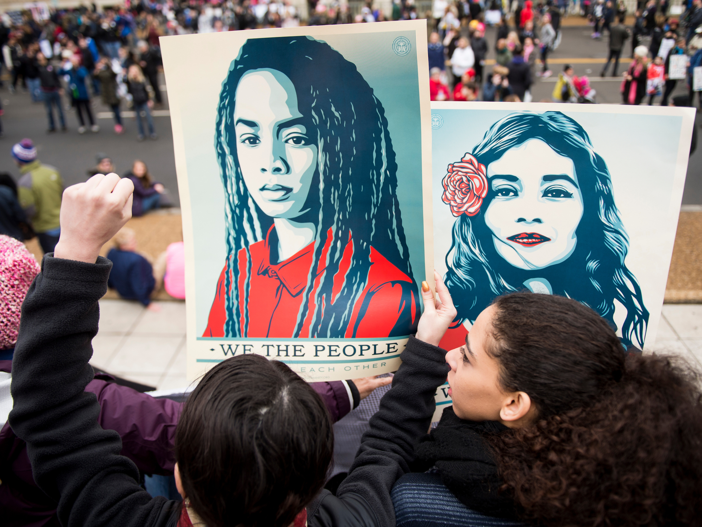 Protesters hold signs along Independence Avenue in D.C. on Saturday. (Bill Clark/CQ Roll Call)