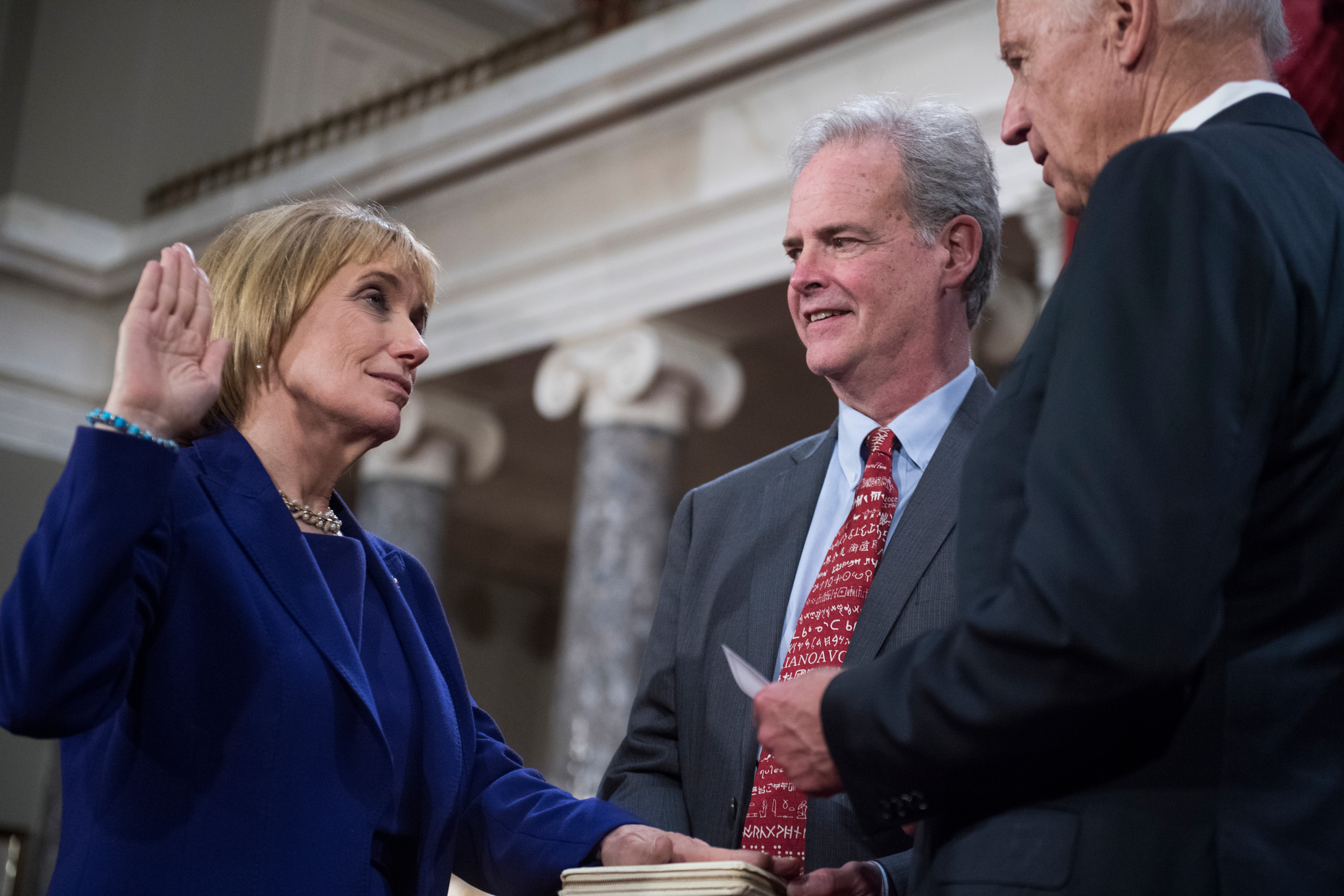 Hassan is sworn in on Jan. 3 by Vice President Joseph R. Biden Jr. as her husband Tom looks on. (Tom Williams/CQ Roll Call file photo)