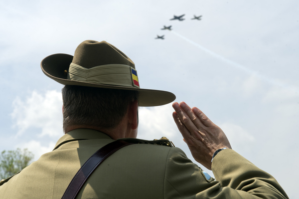 Brigadier Gen. David Creagh of Australia, watches World War II era aircraft as they fly over the World War II Memorial. (Tom Williams/CQ Roll Call)