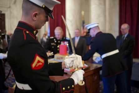 A Marine cleans the sword used to cut the cake during a 240th birthday celebration for the Marine Corps. (Tom Williams/CQ Roll Call)