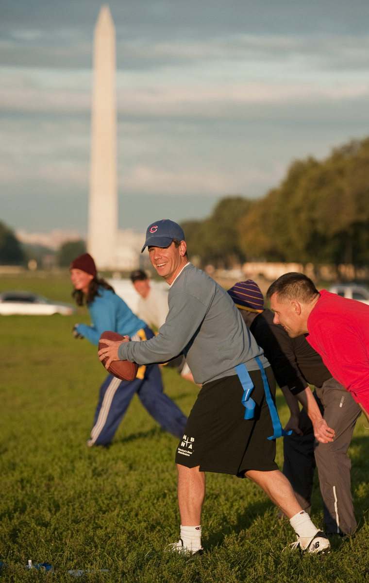 Rep. Bob Dold plays quarterback during a congressional football practice on the Mall in preparation for the upcoming game between members of Congress and the Capitol Police. (Tom Williams/CQ Roll Call File Photo)