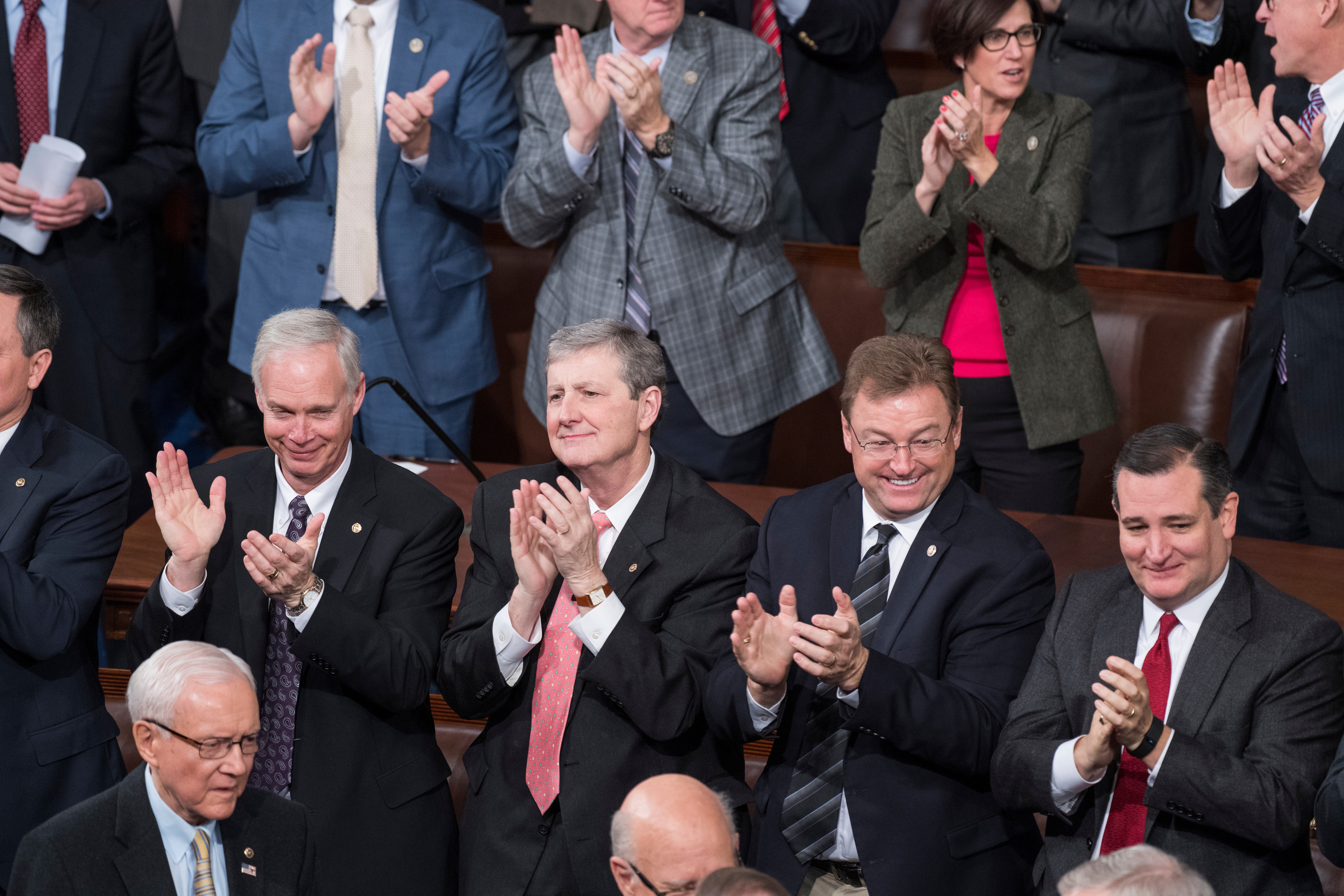 From left, Republican Sens. Ron Johnson of Wisconsin, John Kennedy of Louisiana, Dean Heller of Nevada and Ted Cruz of Texas applaud at the end of the the Electoral College count during a joint session of Congress in the House chamber on Friday. (Tom Williams/CQ Roll Call)