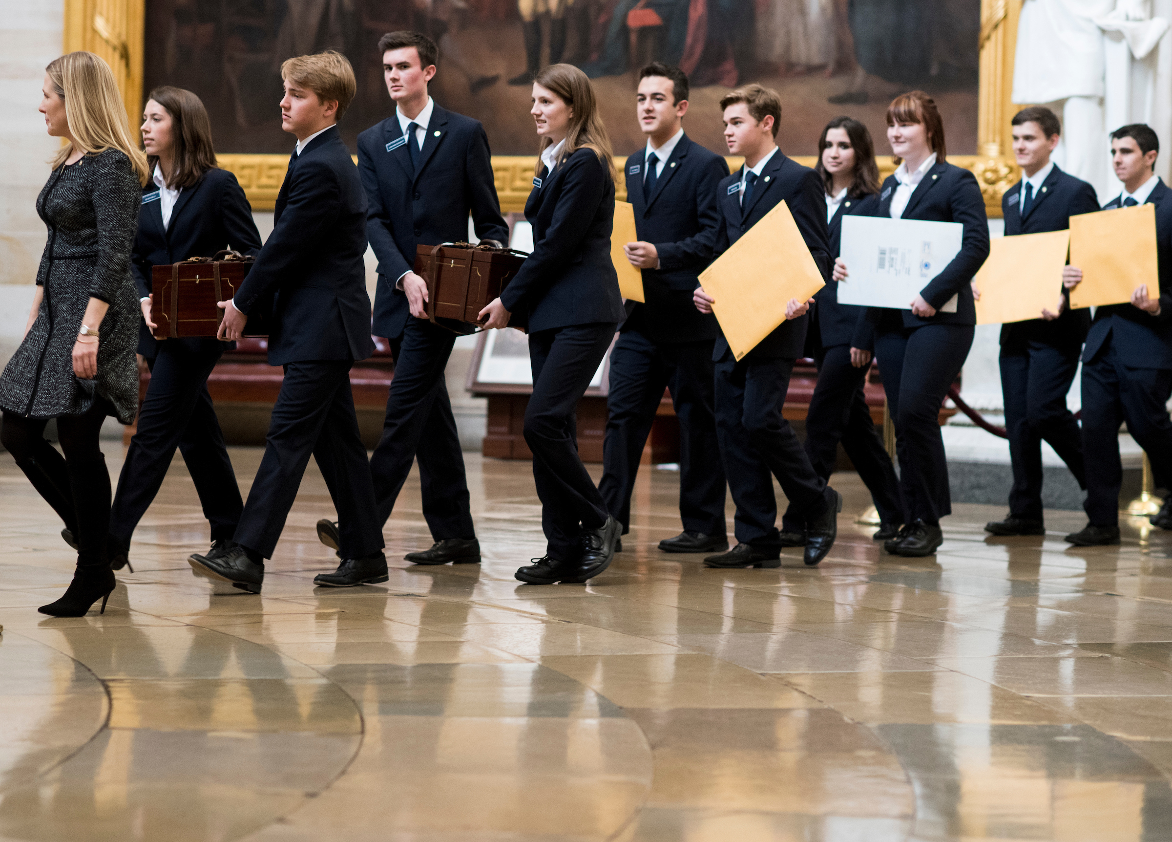 Senate pages lead the procession of the Senate through the U.S. Capitol Rotunda into the House chamber with the Electoral College ballot boxes on Friday. (Bill Clark/CQ Roll Call)