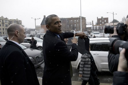 Obama points to his Shinola watch, which he already owned, after visiting a Shinola store in Detroit. (Brendan Smialowski/AFP/Getty Images)