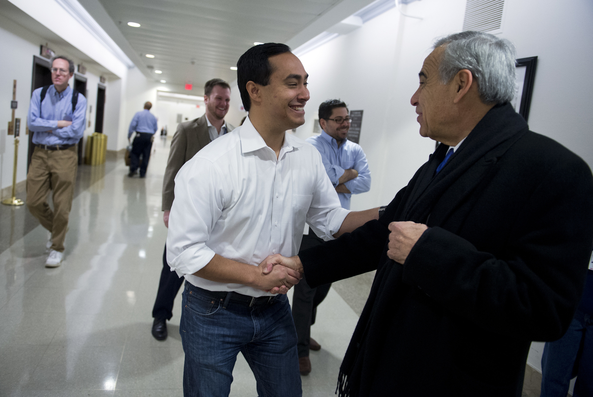 UNITED STATES - JANUARY 02: Rep.-elect Joaquin Castro, D-Texas, left, greets outgoing member Rep. Charlie Gonzalez, D-Texas, in the basement of Longworth Building. Castro is succeeding Gonzalez as representative for Texas's 20th District. (Photo By Tom Williams/CQ Roll Call)