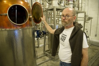 Michael Lowe, co-owner and distiller of New Columbia Distillers, shows of the still for
