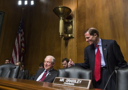 Sen. Jeff Sessions gets a thumbs up from Sen. Richard Blumenthal after Sessions' announcement. (Al Drago/CQ Roll Call)